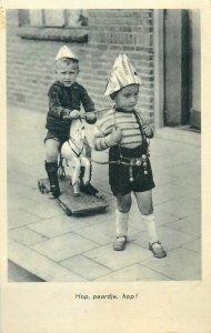 Children games scene 1938 wood rocking horse toy Netherlands postcard