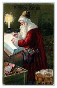 A HAPPY XMAS ~ SANTA Checking His LIST by CANDLELIGHT c1910s Embossed Postcard
