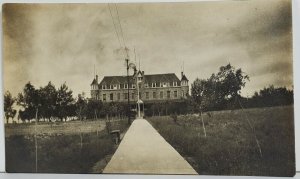 South Dak. RPPC Hot Springs State Soldiers Home US Flag Half Staff Postcard N17