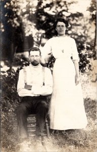 RPPC Poor Woman with Scary Man Seated in Yard c1910 Postcard B22