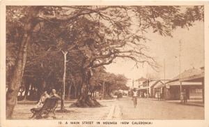 Noumea New Caledonia~A Main Street~Couple on Bench~Storefronts~Trees~c1920s Pc