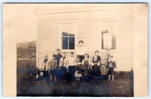 1910-1920's RPPC SCHOOL TEACHER CHILDREN SCHOOLHOUSE LOCATION UNKNOWN POSTCARD