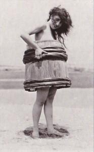 Humour Woman On Beach Wearing Barrel