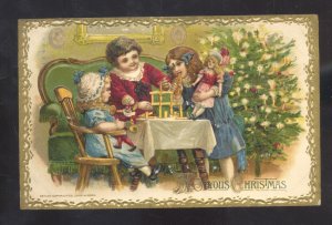 A JOLLY CHRISTMAS CHILDREN AT TABLE WITH DOLLS VINTAGE POSTCARD SEDALIA MISSOURI