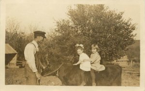 1910s RPPC Postcard 2 Cute Little Girls Riding a Heifer Calf, Unknown Midwest US