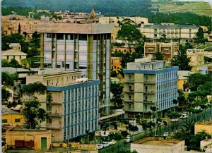 VINTAGE CONTINENTAL SIZE POSTCARD STREET SCENE AND BUILDINGS AT ASMARA ETHIOPIA