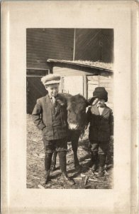 RPPC Young Boys Pose Proudly with Calf c1910 Postcard U19