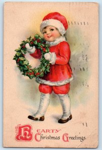 1928 Christmas Greetings Boy Santa Costume Wreath Berries Wolf Vintage Postcard