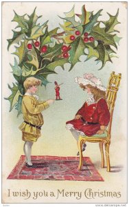 I wish you a Merry Christmas, boy gives a girl sitting in a chair a toy soldi...