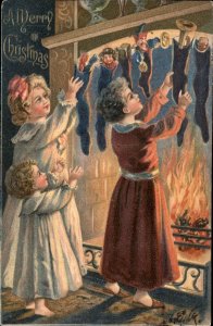Christmas Children Collect Stockings Fireplace c1900-20s Vintage Postcard