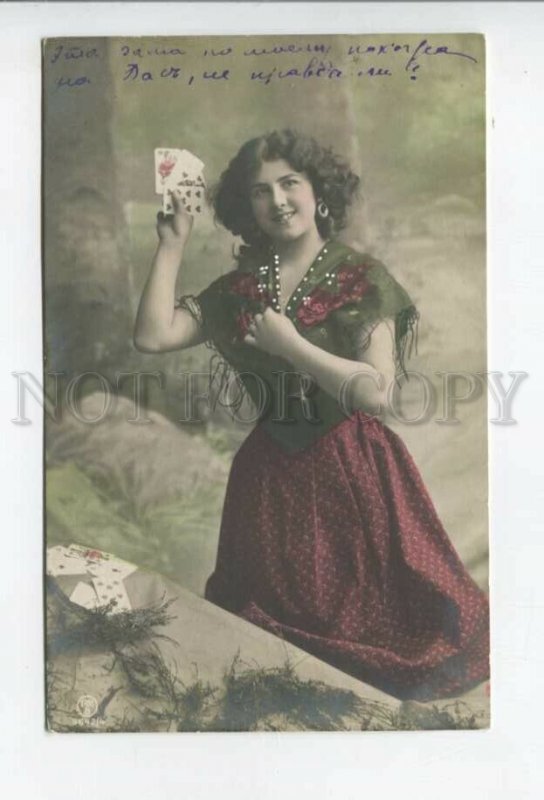 431959 Fortune telling gypsy girl reads cards in her hands Vintage tinted photo 