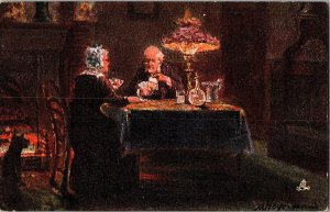 Tucks 9016 Firelight Effects, Old Couple Playing Cards Vintage Postcard N80