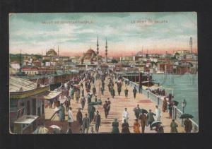 076906 CONSTANTINOPLE Galata bridge men w/ umbrellas Vintage