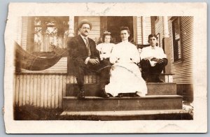 c1910 RPPC Real Photo Postcard Family Group Man Woman Children on Porch