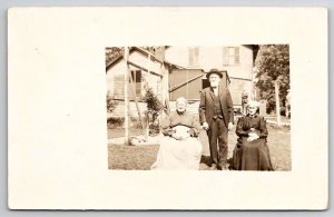 RPPC Old Women Seated in Yard with Man One Large Lady Real Photo Postcard H28