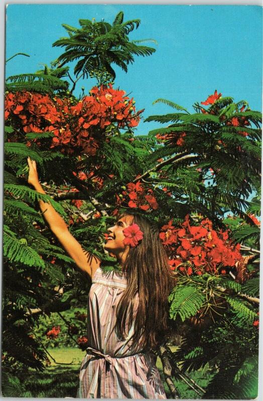 Beautiful woman reaching for flowers in St. Thomas, Virgin Islands 