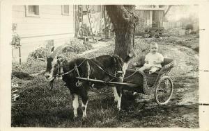 c1920 RPPC Postcard, Confused Looking Baby in Wicker Goat Cart, Unknown US Loc.