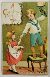 Christmas Joys Be Thine Children Hanging Hollyberry Embossed Postcard T1
