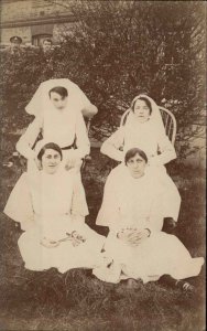 Group Photo Nurses Nursing School Men Peek Over Bushes c1910 RPPC PC