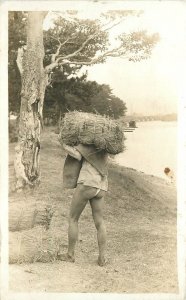 postcard RPPC Philippines Native man reed bundle 23-1638