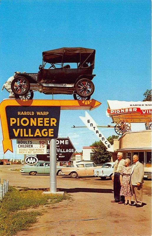 Minden NE Pioneer Village Entrance Covered Wagon Old Cars Signs Postcard