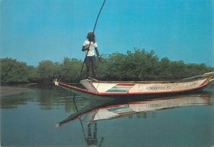 Senegal canoe man postcard 1985