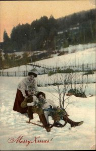Christmas Pretty Woman Mom & Children Sledding Gel c1900s-20s Postcard