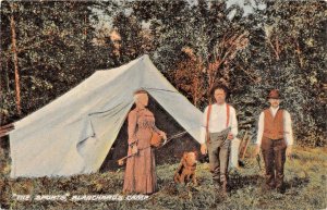 BLANCHARDS CAMP MAINE~THE SPORTS-WOMAN FLY FISHING-MAN W/ PISTOL & DOG POSTCARD 