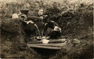 PC CPA washing clothes in a source real photo postcard INDONESIA (a15034)