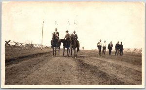 Men Riding Horses Give Walking Roadway Desert Real Photo RPPC Postcard