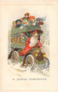 F61/ Santa Claus Merry Christmas Postcard c1910 Driving Motor Bus Kids 25