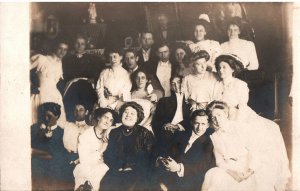 VINTAGE POSTCARD LARGE GROUP OF MEN AND MOSTLY WOMEN ON EARLY REAL PHOTO CARD