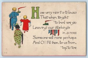 Christmas Postcard Children With Stockings And Candle c1910's Posted Antique