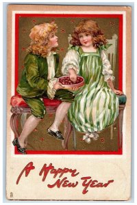 c1910's New Year Boy Girl Eating Chocolates Embossed Tuck's Antique Postcard 