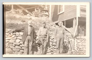 c1922 RPPC Three Men Next to Rock Wall of Home on Hill ANTIQUE Postcard 1319