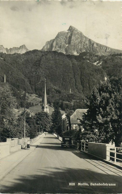 Postcard Switzerland Mollis Bahnhofstrasse Road Mountain Church Forest Car