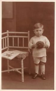 Young boy with a toy Happy New Year 1926 Child, People Photo Writing on back 