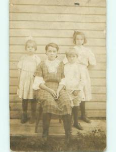 Pre-1920's rppc TWO GIRLS WITH BOWS IN HAIR WITH SIBLINGS r6273