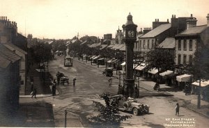 c1915 COCKERMOUTH ENGLAND 631 MAIN STREET AUTOMOBILE CLOCK RPPC POSTCARD P502