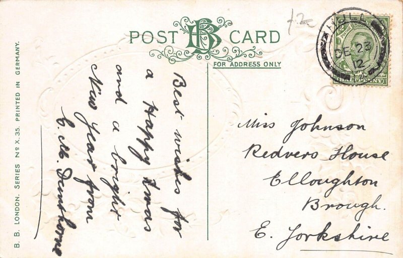 A047 Christmas greetings 1912 mistletoe hut trees snow embossed postcard