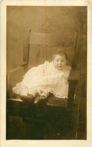 1910 REAL PHOTO POSTCARD RPPC BABY IN LACY DRESS IN CHAIR