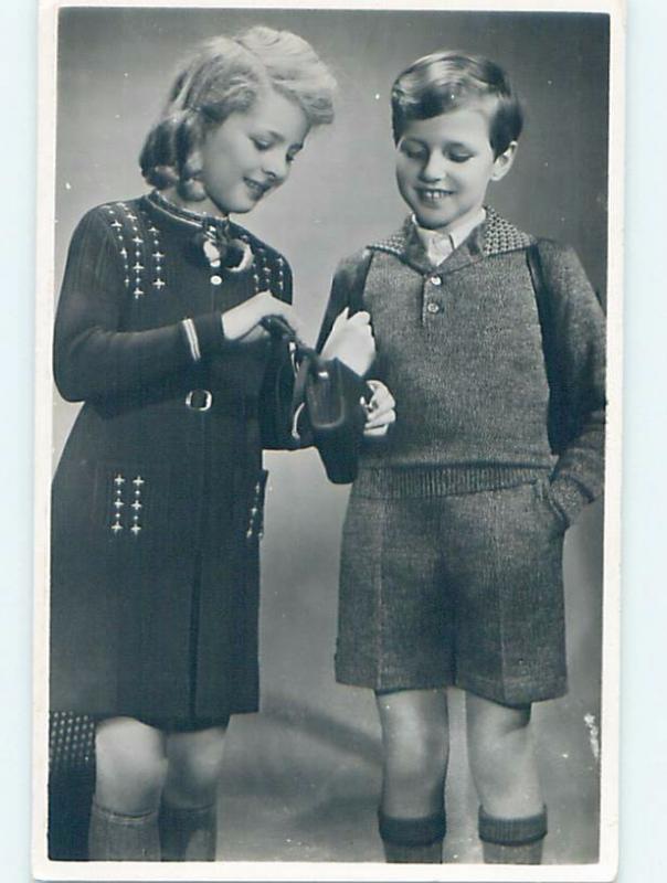 old rppc YOUNG GIRL LOOKS INTO HER VINTAGE HANDBAG PURSE HM1084