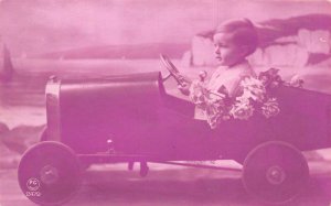 Little Boy Driving Toy Car Pink Red Tinted Real Photo Vintage Postcard AA60099