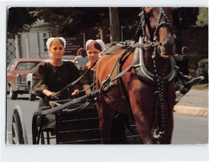 Postcard Young Amish girls ride in the Amish Country, Pennsylvania