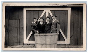 Four Mens Postcard RPPC Photo In Barrel Cask Log Cabin House c1910's Antique