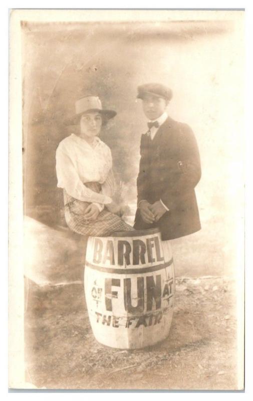 Studio RPPC Young Couple Barrel of Fun at the Fair Real Photo Postcard