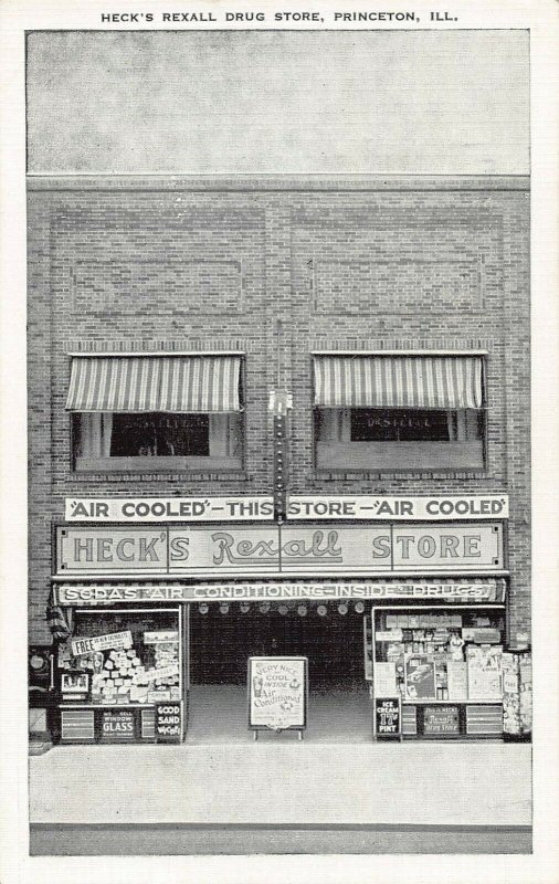 PRINCETON ILLINOIS~HECK'S REXALL STORE-SODAS-DRUGS-AIR COOLED~1950s POSTCARD