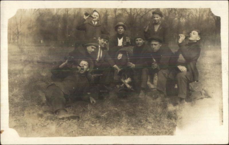 Group of Men Being Silly Drinking Beer From Bottles c1910 Real Photo Postcard