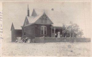 WOMAN ON PORCH OF VICTORIAN HOUSE IN THE SNOW~1910s REAL PHOTO POSTCARD