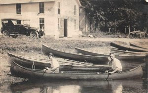 RPPC COUPLE IN CANOE CAR HOUSE REAL PHOTO POSTCARD (c. 1920s)